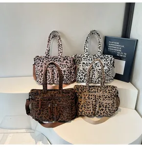 Detailed display of four leopard print corduroy tote bags with dual front zipper pockets