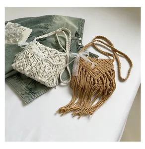 Detailed close-up of woven bohemian tassel bags with lace bow and pearl decoration
