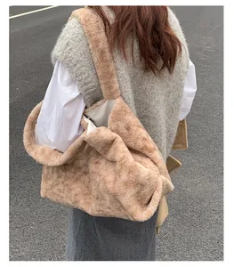 Detail of soft brown plush tote bag showing wide shoulder strap and spacious interior