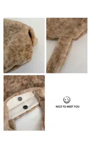 Detail of plush brown tote bag showing magnetic closure and faux leather lining