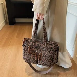 Fashionable leopard print corduroy tote bag with multiple pockets and woven zipper pulls
