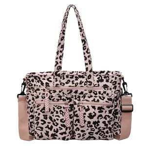 Pink leopard print corduroy tote bag with dual front pockets and shoulder straps