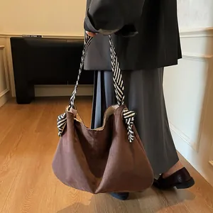 Brown suede tote bag with large capacity and striped woven strap for autumn fashion