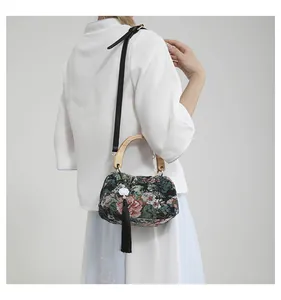 Detail of Chinese style jacquard handbag with floral embroidery and wooden handle