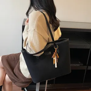 Minimalist black matte tote bag with vintage beaded tassel and large capacity for women