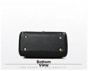 Detail view of the bag's textured leather bottom featuring four gold protective metal studs