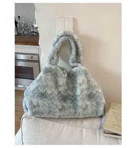 Detail of blue and white plush faux fur tote bag with soft texture and sturdy handles