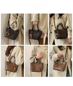 Multiple carrying styles of women's vintage bucket bag in dark and light brown leather