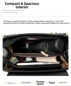 Detail view of black lychee grain leather handbag with three interior compartments