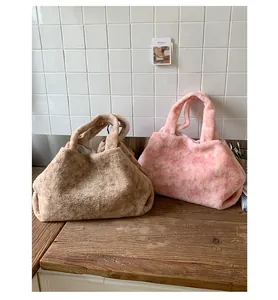 Detail shot of plush brown and pink tie-dye tote bags with soft faux fur texture