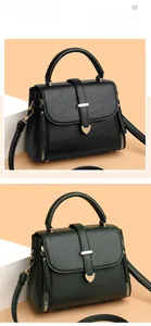 Detail view of black and dark green PU leather bags with golden heart-shaped metal locks