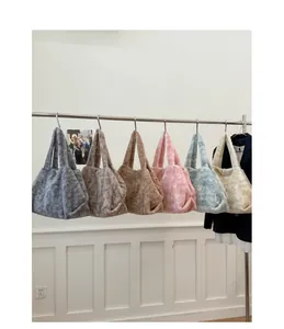 Detailed display of plush tote bags in six autumn colors hanging on a metal rack