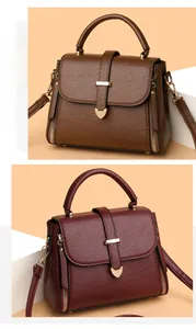 Detail of lychee textured leather tote bag with heart-shaped golden magnetic clasp