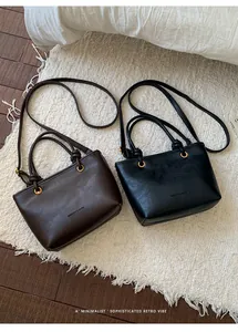 Close-up of retro PU leather tote bags in brown and black with elegant knotted handles
