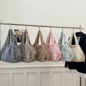Fuzzy faux fur tote bags in six colors hanging on a metal rack for winter fashion