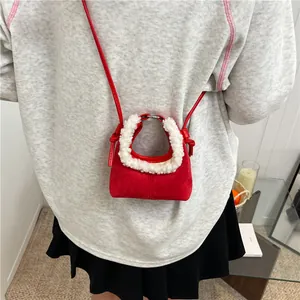Red lamb wool patchwork dumpling bag with suede finish and silver handle shown on model