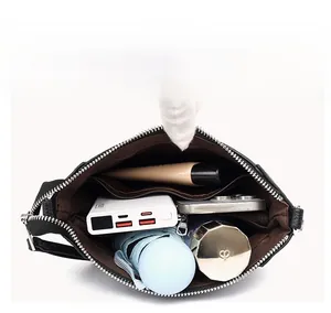 Interior detail of a black crossbody bucket bag showing spacious storage with inner pockets