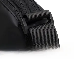Macro detail of high-density nylon shoulder strap and reinforced D-ring on a black bag