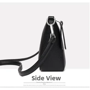 Side view of black lychee grain leather bucket bag with silver metal hardware and strap