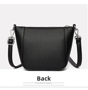 Detailed back view of a black litchi pattern bucket bag with silver hardware and strap