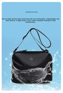 Close-up of waterproof nylon crossbody bag showing water splashes on high-density fabric