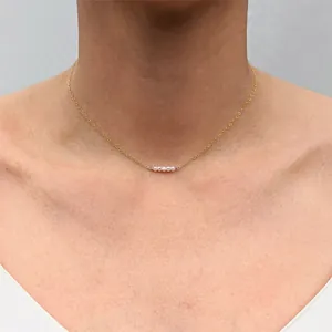 Minimalist 18k gold plated choker necklace featuring four elegant white freshwater pearls