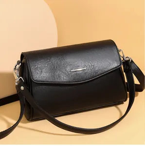 Detail of black retro shoulder bag showing smooth PU leather texture and silver buckle