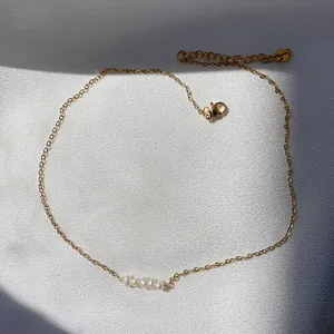Detail showing high-quality natural freshwater pearls on 18k gold plated necklace chain