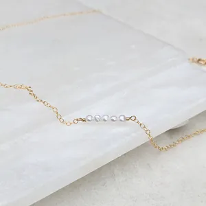 18k gold plated titanium necklace featuring five natural freshwater pearls on a slim chain