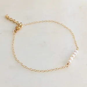18k gold plated titanium necklace with five natural freshwater pearls on a delicate chain