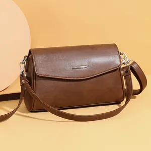 Retro dark brown leather shoulder bag for women with minimalist silver metal bar hardware