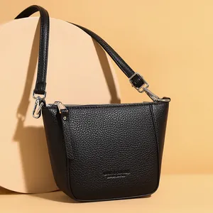 Classic black lychee texture bucket bag with adjustable strap and silver zipper closure
