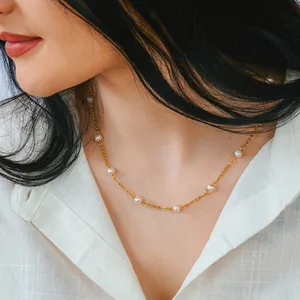 Close-up of 18k gold plated titanium chain necklace with natural freshwater pearls