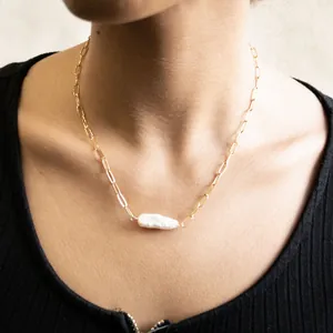 Detail of 18k gold plated paperclip chain necklace with a natural baroque pearl charm