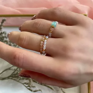 Detailed close-up of three handmade beaded rings with turquoise and moonstone-style beads
