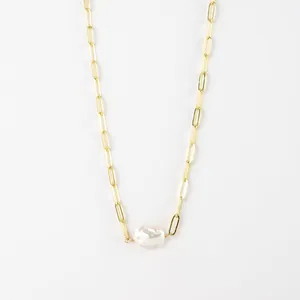 Detail view of gold paperclip chain necklace with a natural baroque pearl pendant