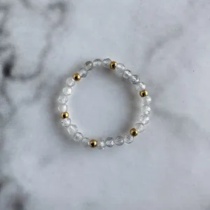 Detail of beaded ring featuring faceted grey natural stones and gold metal spacers
