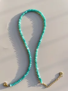 Detail of turquoise beaded necklace with 18k gold plated lobster clasp and extender chain