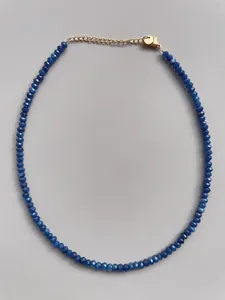 Detail of blue natural stone beaded necklace with 18k gold plated clasp and extender