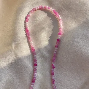 Handmade beaded necklace with faceted pink and purple natural stones on champagne silk