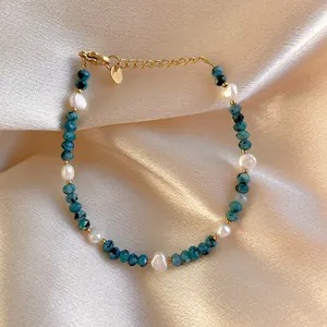 Détail de pierres bleues et perles baroques sur un bracelet plaqué or 18 carats