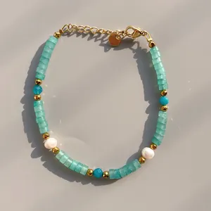 Detail of sea blue natural stones and freshwater pearls with a gold extender chain