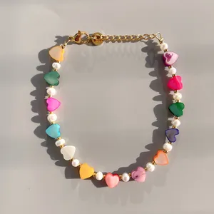 Detail of colorful heart beads and freshwater pearls on a vibrant charm bracelet