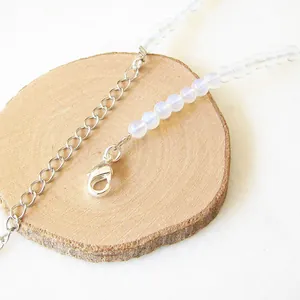 Dettaglio della collana di perline con chiusura a moschettone e pietre lattee