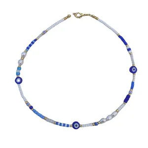 Bohemian Evil Eye necklace with colorful beads and baroque pearls on white background