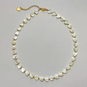 Detail of mother of pearl heart bead necklace with gold plated chain and clasp
