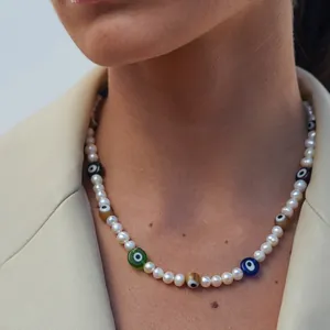 Freshwater pearl necklace with colorful evil eye beads worn by a fashion model