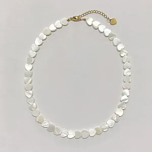 Detailed view of handmade beaded heart shell necklace with 18k gold lobster clasp