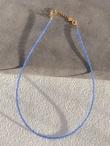 Detail of blue faceted bead necklace with gold-plated lobster clasp and adjustable chain