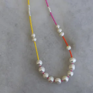 Bohemian style freshwater pearl necklace with colorful beads on a marble background
